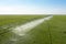 Watering system in the field. An irrigation pivot watering a field.