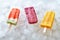 Watermelon, berry, peach, homemade ice lolly on ice cubes. Sweet cold dessert. Flat lay