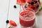 Watermelon, blackberry smoothies with straw and pieces of fruit