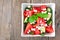 Watermelon, cucumber and feta cheese salad on a wood background