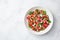 Watermelon, cucumber, feta and mint salad in white bowl