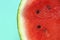 Watermelon in a cut on a green background. Watermelon pulp close-up. red watermelon half.Appetizing summer fruits.