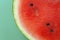 Watermelon in a cut on a green background. Watermelon pulp close-up. ripe red watermelon half.Appetizing summer fruits.