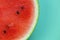 Watermelon in a cut on a green background. Watermelon pulp. ripe red watermelon half.Appetizing summer fruits.