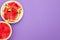 Watermelon cut in half and slices isolated in violet heliotrop background with copy space viewed from above