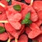 Watermelon hearts on sticks with mint closeup.