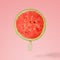 Watermelon with ice cream stick on pink background.