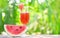 Watermelon juice summer with piece watermelon fruit on glass on nature green background