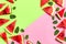 Watermelon pattern. Juicy slices of ripe red watermelon and mint leaves on multicolored pink and green background. Flat lay, top