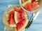 watermelon piece organic summer refreshment of a plate on a blue wooden background