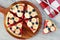 Watermelon pizza with bananas, blueberries and yogurt on serving board