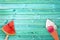 Watermelon popsicle and ice cream cone on blue planks background with copy space