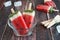 Watermelon popsicles in a clear bowl against a rustic wood