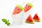 Watermelon popsicles homemade on ice glass and mint white background
