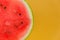 Watermelon pulp. Watermelon cut on a yellow background.Fresh ripe red watermelon half. Appetizing summer fruits.