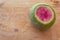 Watermelon radish sliced open on a weathered wood table, copy space