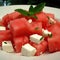 Watermelon salad with feta cheese and mint on a white plate