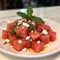 Watermelon salad with feta cheese and mint on a white plate