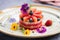 watermelon salad garnished with edible flowers on a white ceramic plate