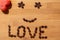 Watermelon seeds on wooden background, smiley face with love word