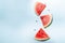 Watermelon slice falling on pastel background. Floating fruits in the air.