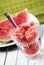 Watermelon slice and melon sweet dessert smoothie on white table. Summertime refreshment detox food. Summer fruit cold slush