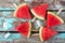 Watermelon slice popsicles on rustic wood background