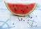 Watermelon slice on tablecloth with sea and marine detail, anchor and rudder