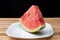 Watermelon in slice on a white crockery on wood, selective focus