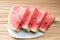 Watermelon in slice on a white crockery on wood, selective focus