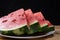 Watermelon in slice on a white crockery on wood, selective focus
