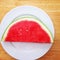 Watermelon slice on a white plate