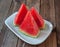 Watermelon sliced pieces on wooden background