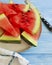 Watermelon slices , nutritious yummy towel freshness sweet summertime on a blue wooden background