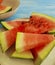 Watermelon slices, plate on a blue wooden background