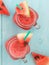 Watermelon smothie and slices on blue background