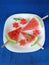 Watermelon. Watermelon pieces formed as popsicles and as stars on a white plate