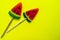 Watermelon wedge lollipop on bright yellow background. Copy space.