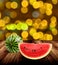 Watermelon on wooden tabel with yellow bokeh light