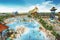 waterpark with massive water slide and towering drop, in the midst of a bustling crowd