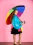 Waterproof accessories manufacture. Kid girl happy hold colorful umbrella wear waterproof cloak. Waterproof accessories