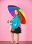 Waterproof accessories manufacture. Kid girl happy hold colorful umbrella wear waterproof cloak. Waterproof accessories