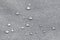 Waterproof droplets on fabric. Grey Canvas Polyester texture synthetical for background. Black polyester textile backdrop for