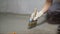 Waterproofing concrete mortar. The master puts waterproofing on a concrete floor with a brush