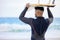 The waters looking perfect. Shot of a young man holding a surfboard at the beach.