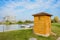 Waterside cabin on grassy lawn in sunny winter afternoon