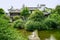 Waterside Chinese traditional houses in woods on sunny summer da