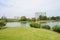 Waterside grassy lawn in cloudy winter afternoon