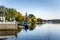 Waterside Houses and Boats Moored to Wooden Jetties under an Autumnal Clear Sky