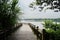 Waterside planked footbridge in cloudy summer